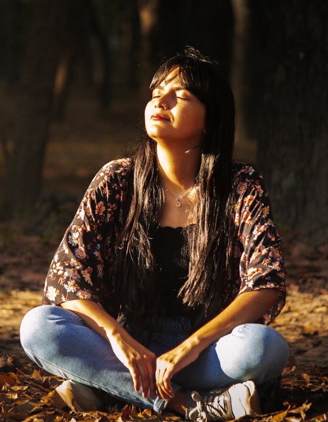 a woman savouring sunshine in nature